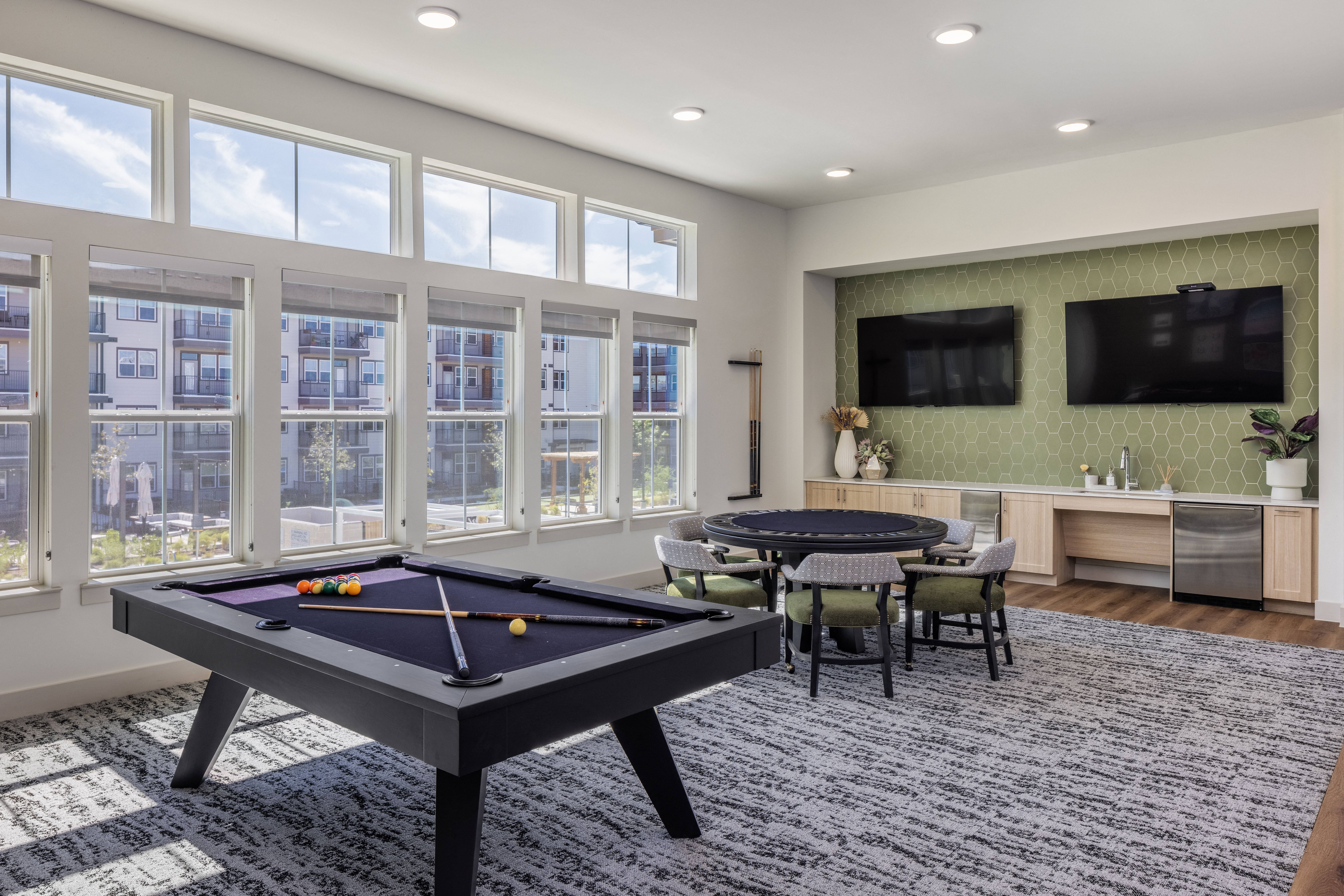 a game room with a pool table and a tv